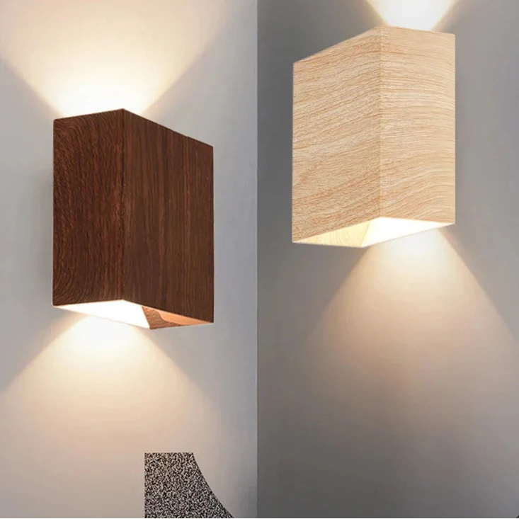 Warm LED beams glow upward and downward in chic contrast from dark and light wooden wall lights.