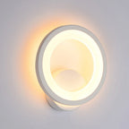 Modern white LED wall light with glowing ring creates a soft, warm halo effect.