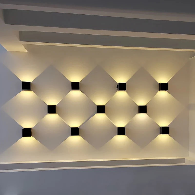 Warm LED light shines both upward and downward, creating a striking artistic wall glow.