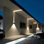 ORLUNE HOME LED Wall Light with PIR casts striking up/down beams on modern façade.