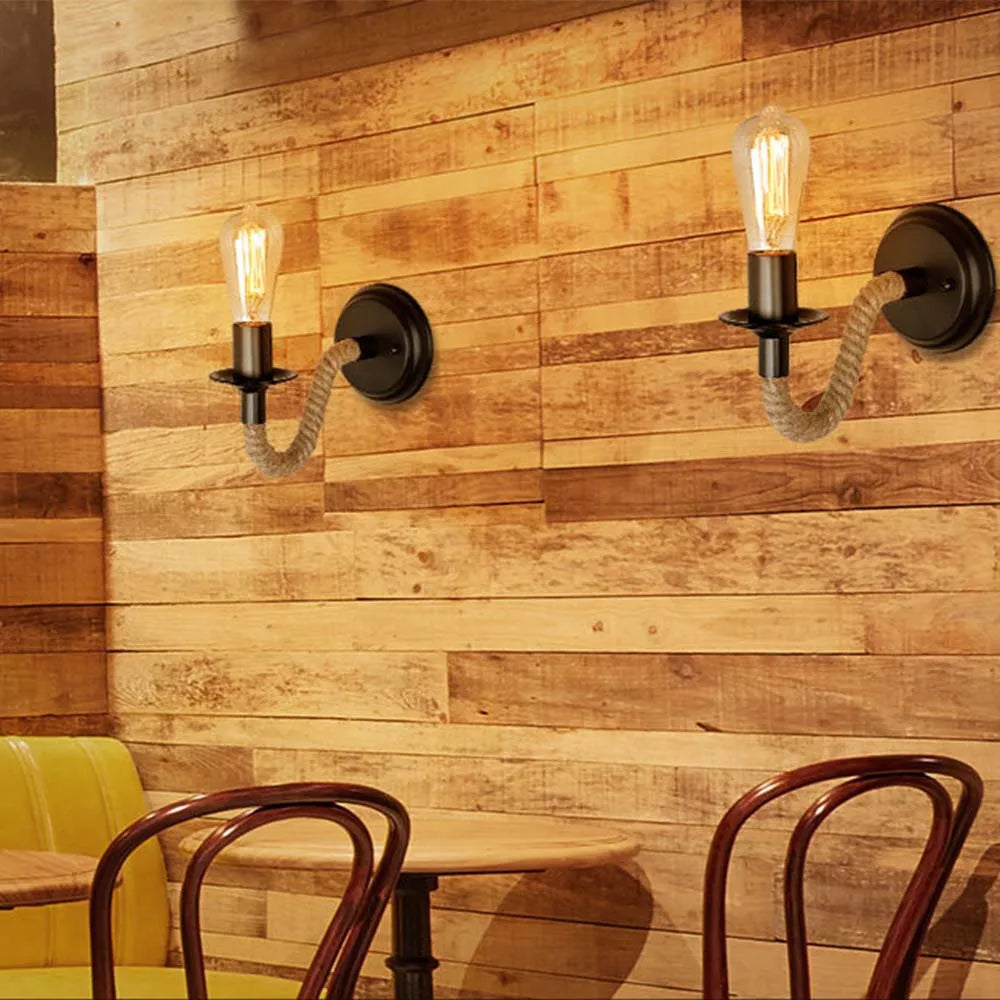 Warm light glows from an industrial ORLUNE HOME sconce with painted metal and exposed bulb.