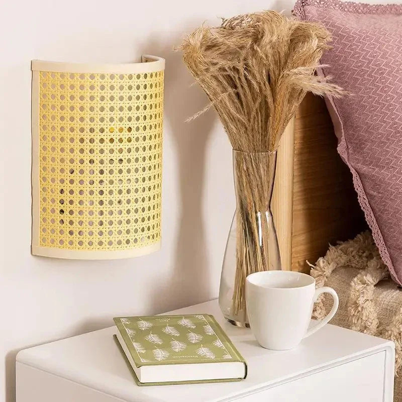 The ORLUNE HOME Japanese Rotin Wall Light casts a warm, inviting glow nearby.