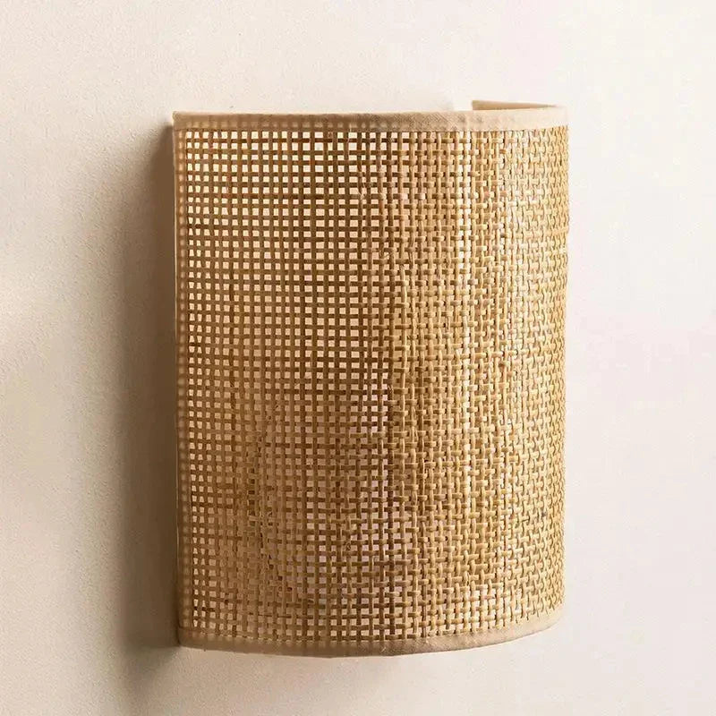 Soft LED light filters through the rattan shade, creating warm, patterned illumination.