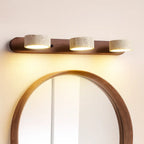 Applique murale LED minimaliste en bois clair et travertin, lumière douce descendante.