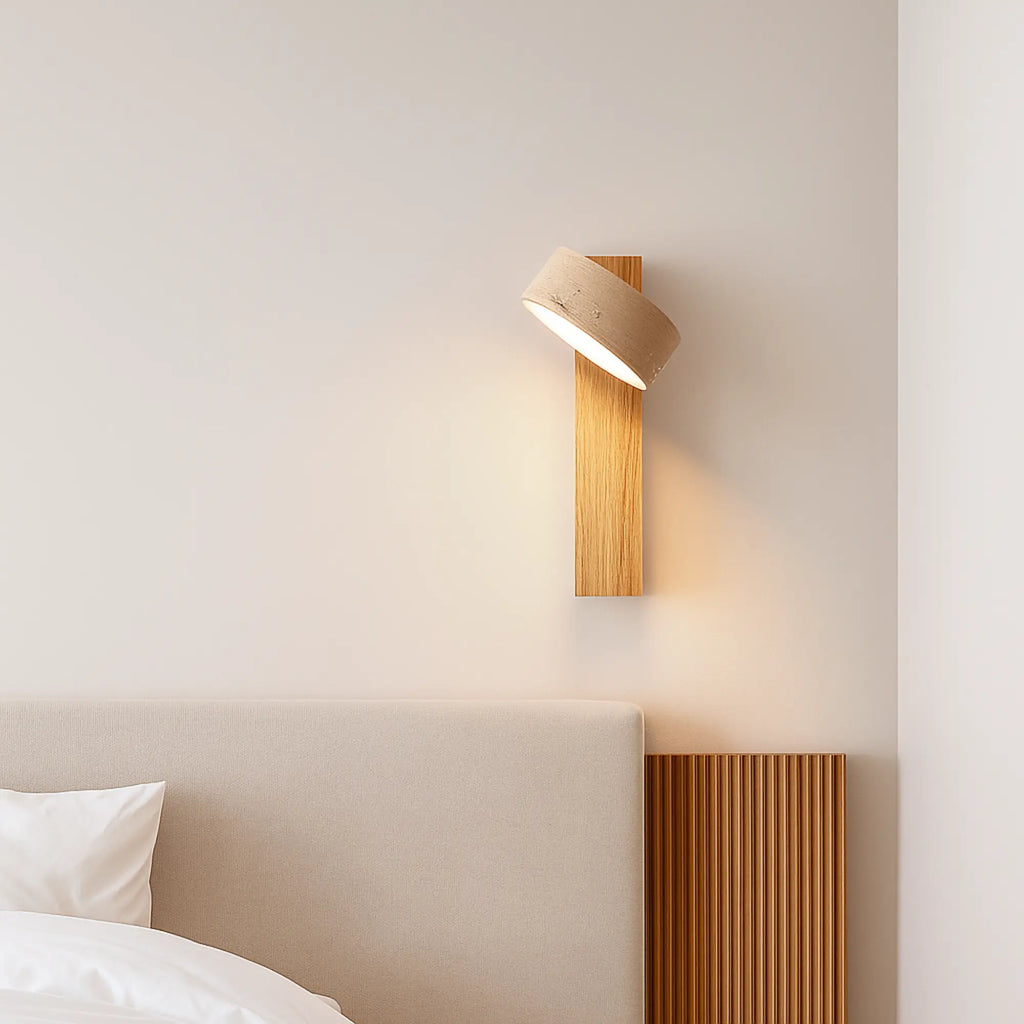 Soft LED wall sconce offers gentle, ambient lighting, enhancing the minimalist bedroom’s tranquility.