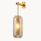Warm LED light softly glows through a gold arm, glass shade, and mesh cylinder.