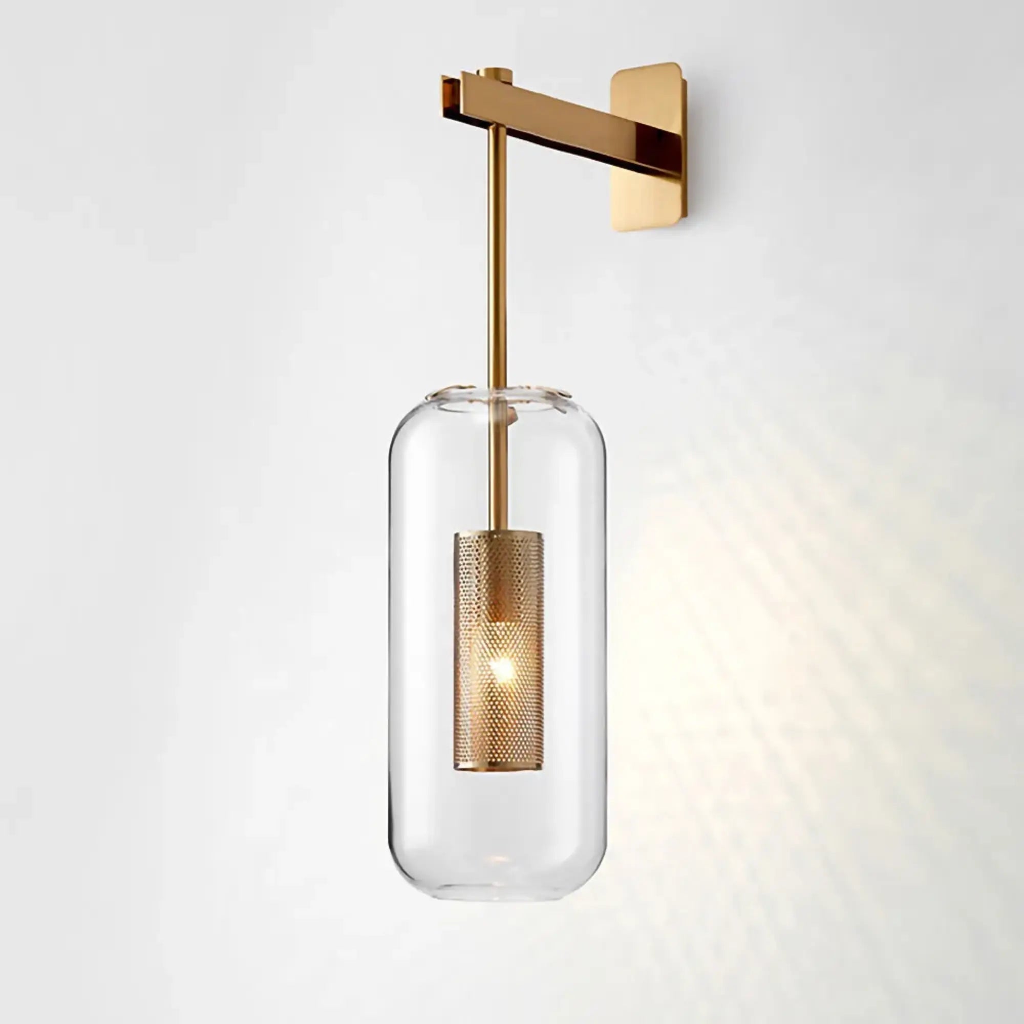 This gold-arm wall light casts warm, patterned LED illumination through clear glass and mesh.