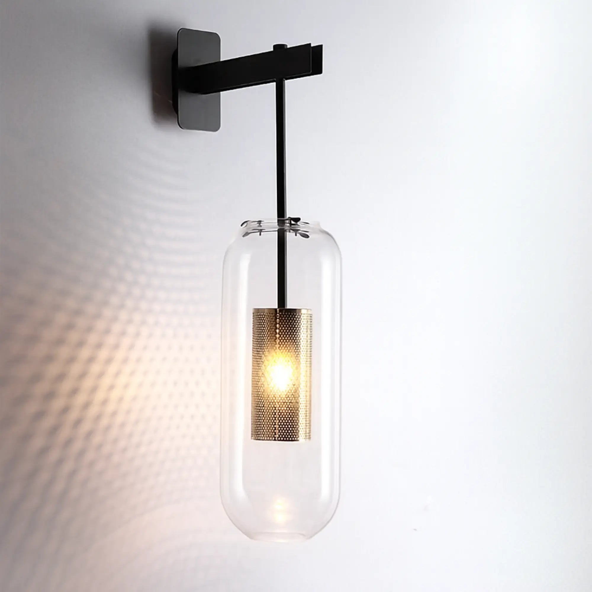 Modern LED wall light with glass shade casts soft decorative patterns when illuminated.