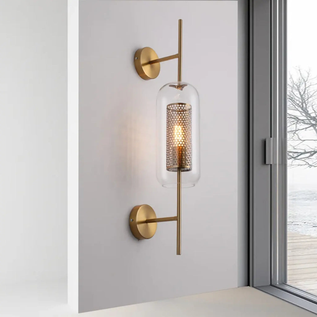 Modern gold-accented wall light adds a bright, elegant glow with perforated glass tube.