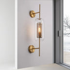 Modern gold-accented wall light adds a bright, elegant glow with perforated glass tube.