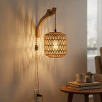 The rattan wall light glows softly, casting beautiful patterned shadows on the nearby wall.