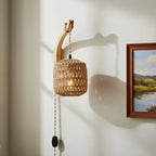 This rattan wall light with wood base creates unique shadows and cozy illumination.
