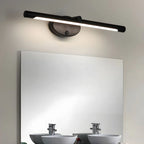 Applique murale LED tactile noire, installée au-dessus d'un miroir, diffuse une lumière intégrée.