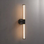 Black circular base with vertical cylindrical fixture, LED wall light casts a warm glow.