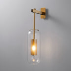 Brass arm, cylindrical glass shade, iron mesh cylinder around bulb in black and gold.