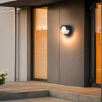 Warm LED wall light with motion sensor brightens entry with soft, inviting illumination.