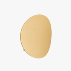 Gold minimalist LED round wall light with a smooth aluminum surface, viewed close-up.