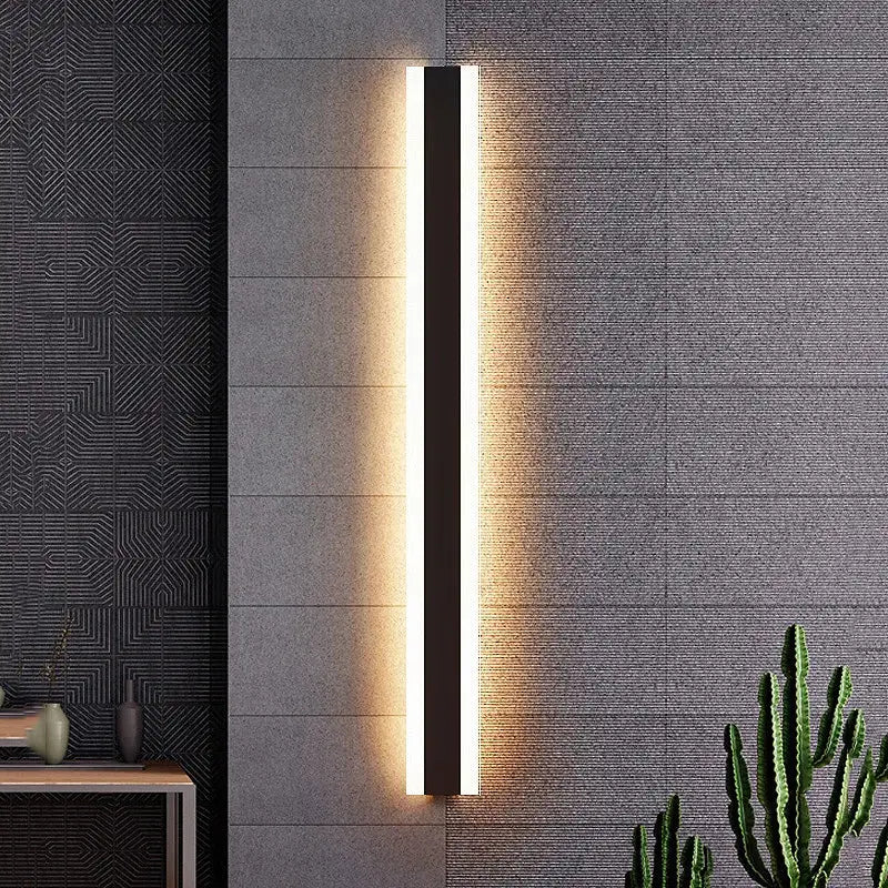 Extra Large waterproof black aluminum LED wall light with sleek strip design on gray wall.