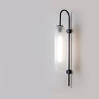 Frosted cylindrical glass wall light with black metal frame, modern industrial style, soft glow.
