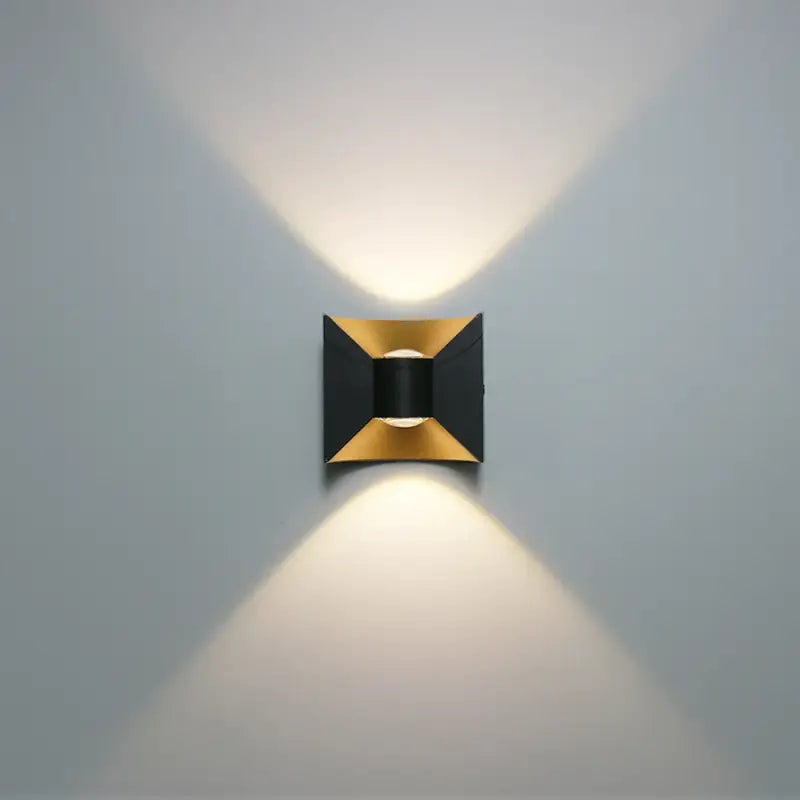 Geometric black and gold curved wall light with waterproof LED, casts soft up-and-down glow.