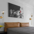 An Elegant Brushed Steel Glass Wall Light with sleek lines casts a soft, modern glow.