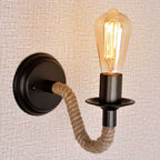 Industrial vintage hemp wall sconce with black base, rope arm, and exposed Edison bulb.