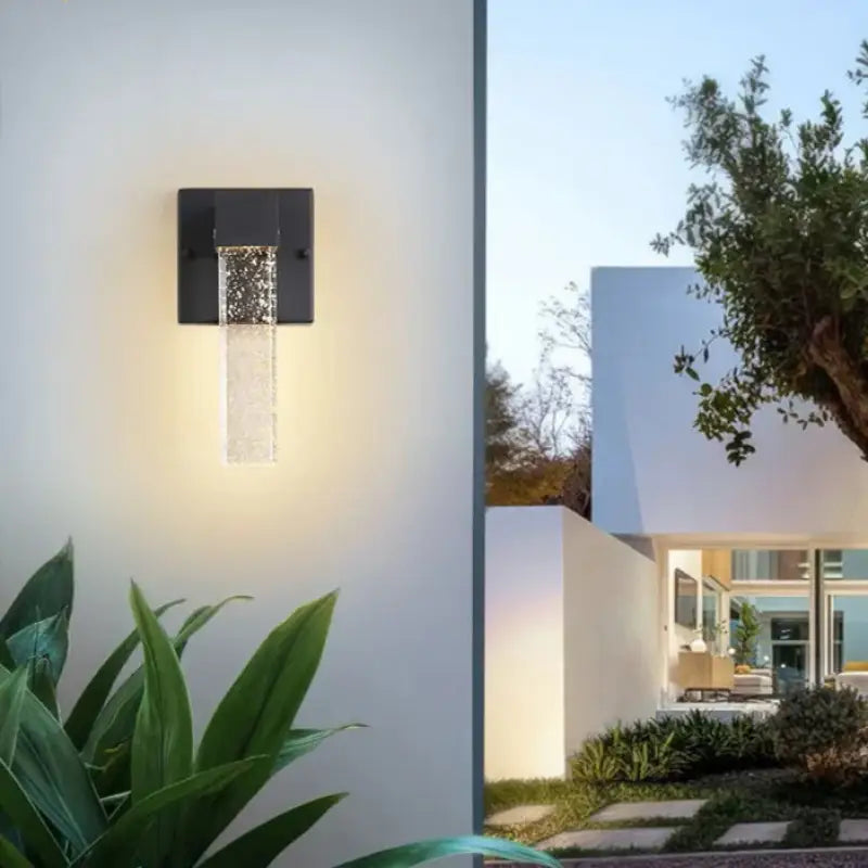 Integrated LED wall sconce with elegant crystal aluminum, emits soft, warm light in modern style.