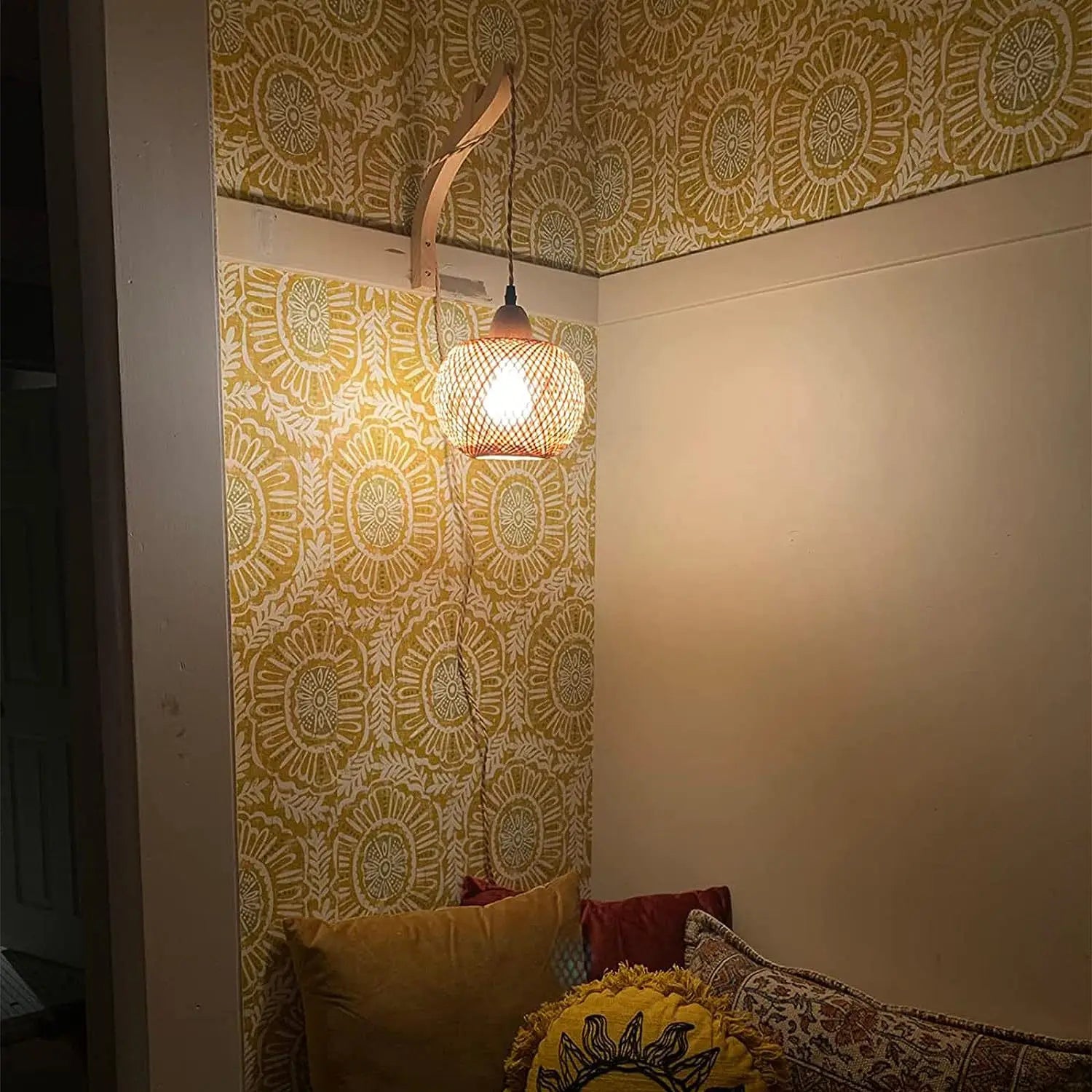 The ORLUNE HOME Bamboo and Rattan Staircase Wall Lantern casts a soothing, warm glow.