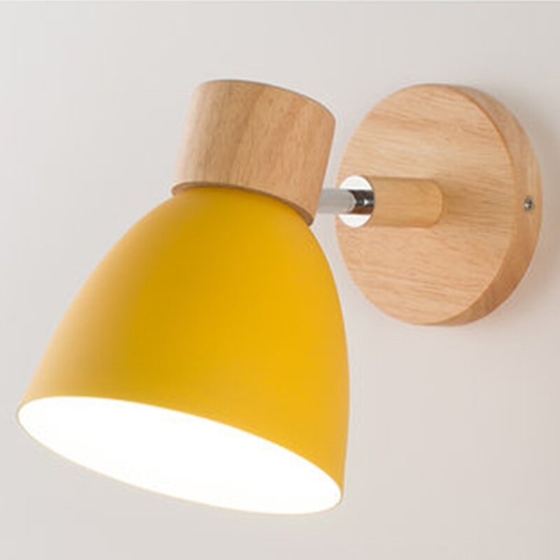 Minimalist wall light with round wood base, yellow metal shade, and 360° rotation.