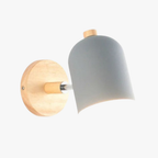 Minimalist wall sconce with round wood base and white metal ball shade, isolated on white.