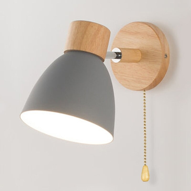 Modern Scandinavian wall light with wooden base, neck, gray shade, and pull chain switch.