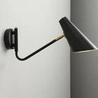 Black cone-shaped industrial wall light with brass accents, angled outward, LED-compatible.