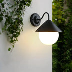 Modern black outdoor wall light with white glass globe and sleek, contemporary design.