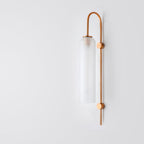 Modern industrial glass wall light with frosted cylinder shade and vertical copper rod bracket.