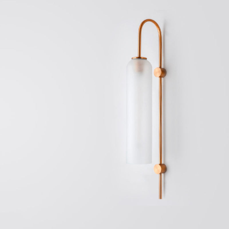 Modern industrial glass wall light with frosted cylinder shade and vertical copper rod bracket.