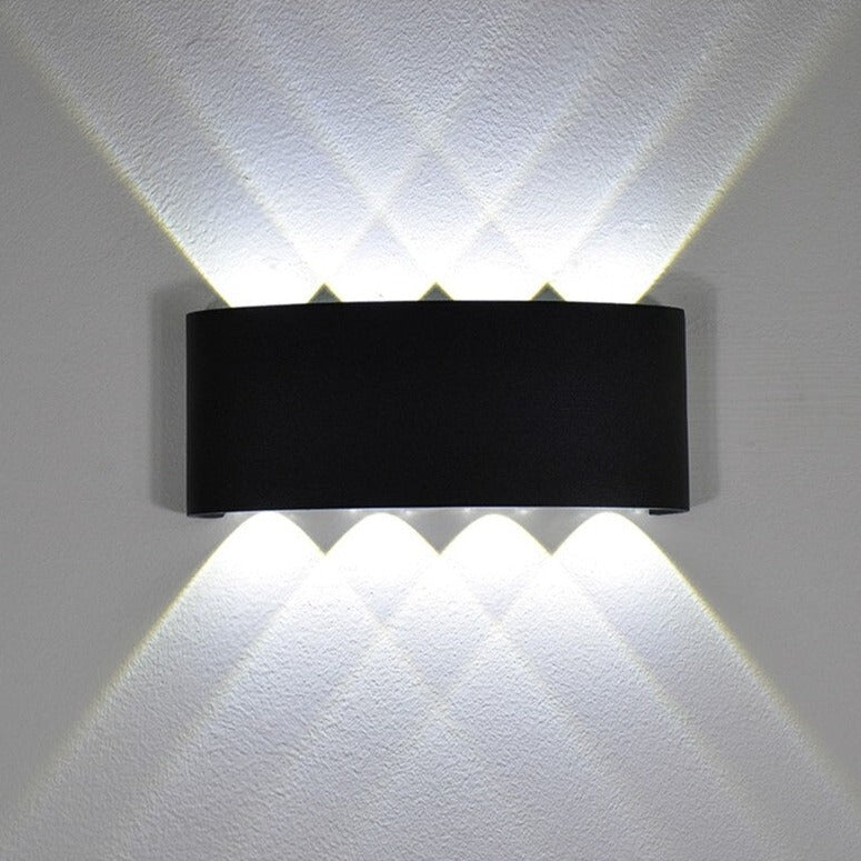 Modern white wall light with diamond geometric design, six beams in a crisscross pattern.
