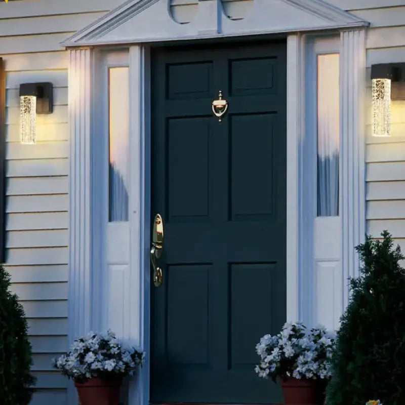 Outdoor Crystal Aluminum Soft Lighting Wall Sconce with crystal detail mounted on white exterior wall.