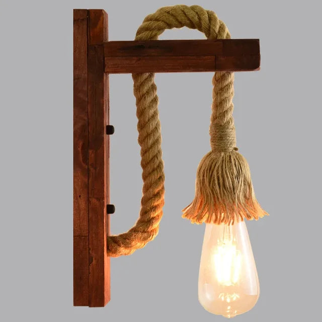 This wall light casts rustic, warm illumination with its hemp rope and exposed glowing bulb.
