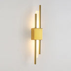 Sleek black and gold metal kitchen wall light with warm LED glow from behind.