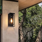 Sleek black metal outdoor wall light with exposed bulb and IP65 rating, modern design.
