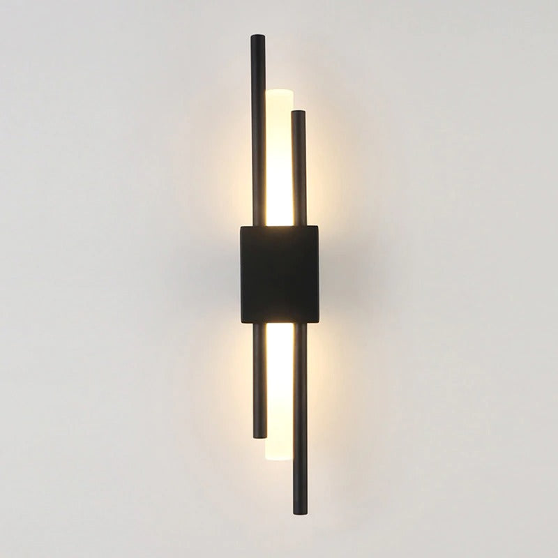 Sleek black rectangular wall light with four vertical rods, two lit by warm LED.