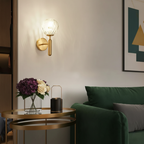 The Helena Modern Industrial Glass Wall Light with sleek glass shade and warm, ambient glow.