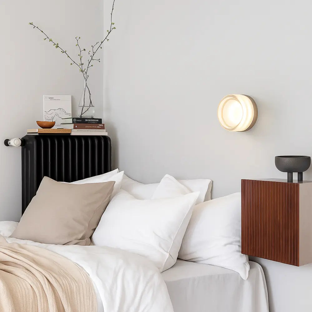 The Scandinavian Design Round Blown Glass Wall Light glows softly, casting a warm, ambient light.