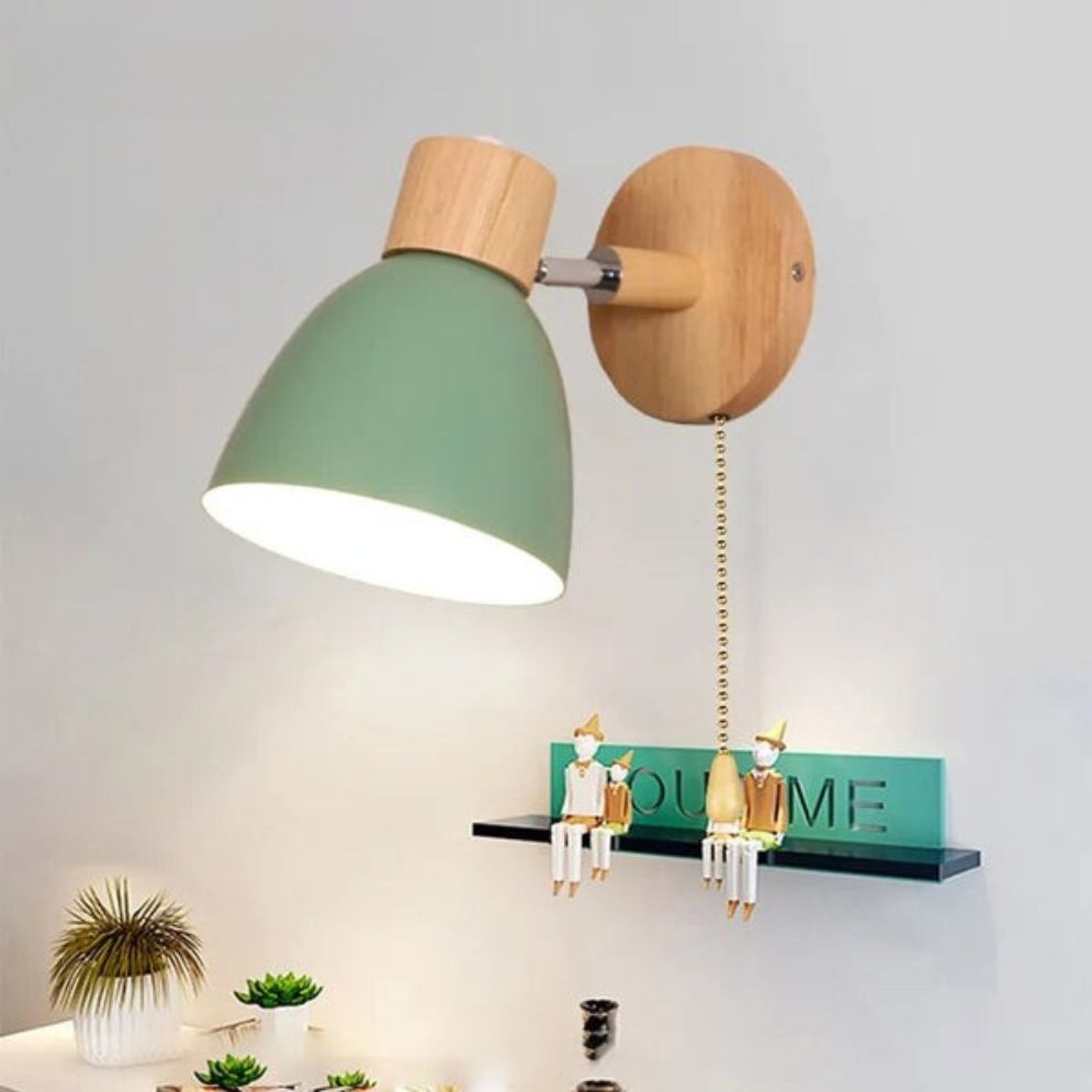 Adjustable green metal-shade wood wall light, LED-compatible, mounted on the wall, illuminated.