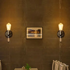 Two Industrial Vintage Hemp Stairway Wall Sconces with exposed filament bulbs on a warmly lit wall.