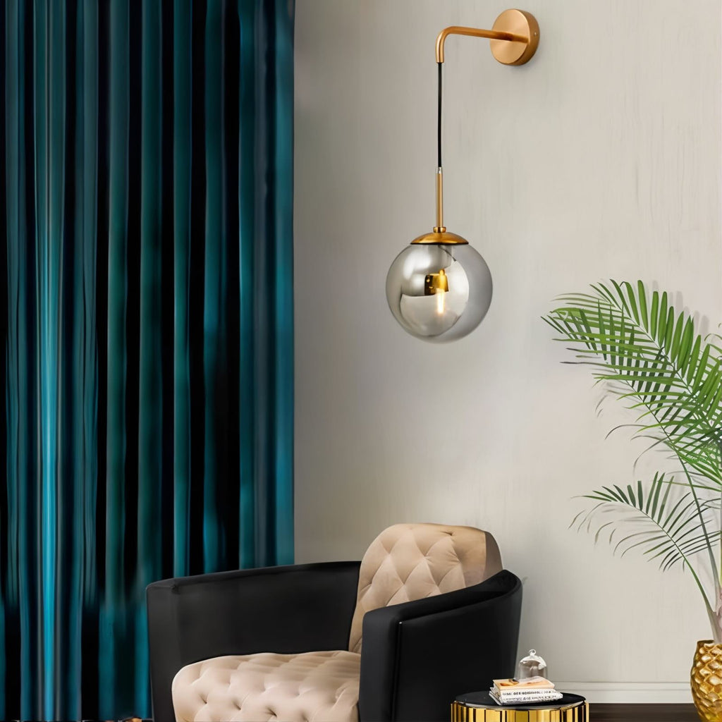 Tyla Modern Metal Glass Wall Sconce in black and gold, mounted for stylish illumination.