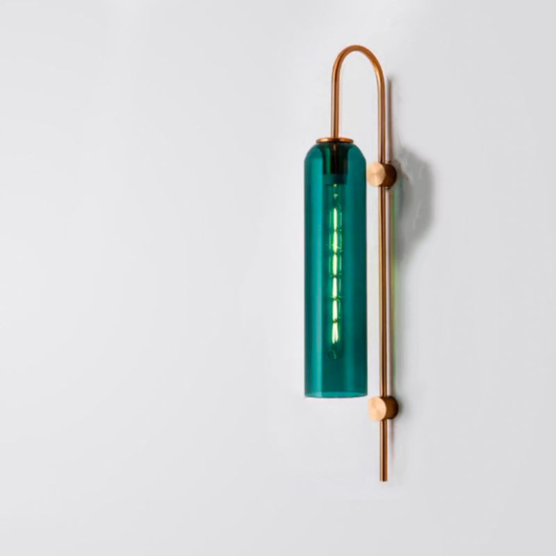 Vertical green glass wall light with copper accents on metal bracket, softly glowing.