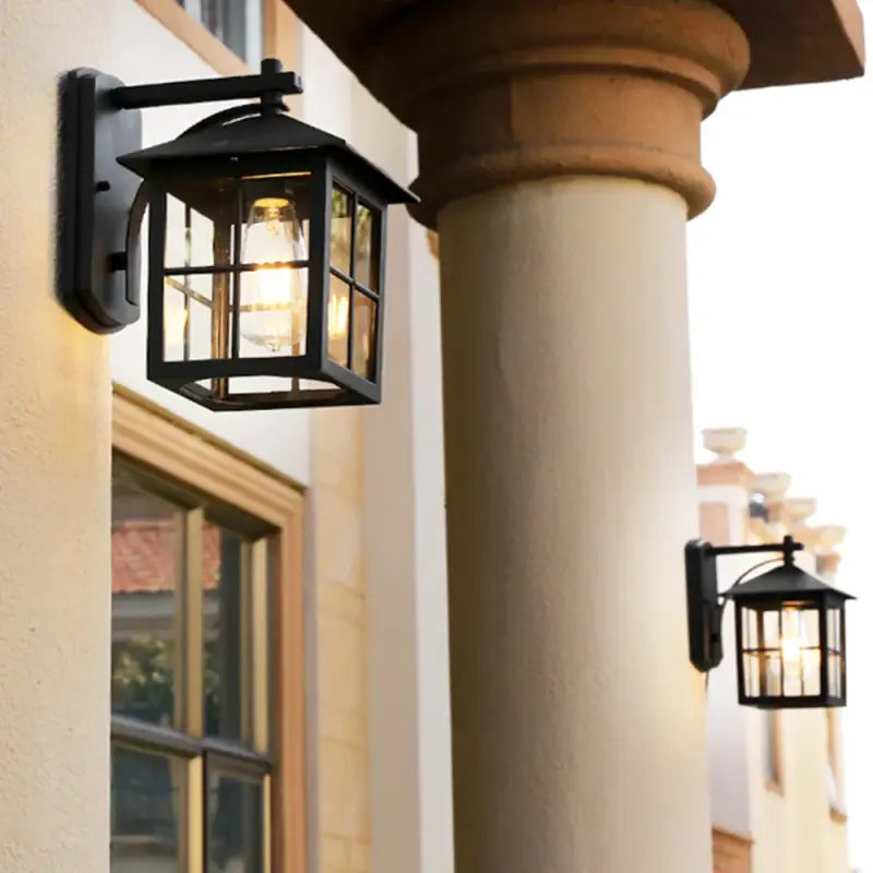Vintage metal and glass wall lantern with retro design mounted on a beige wall.