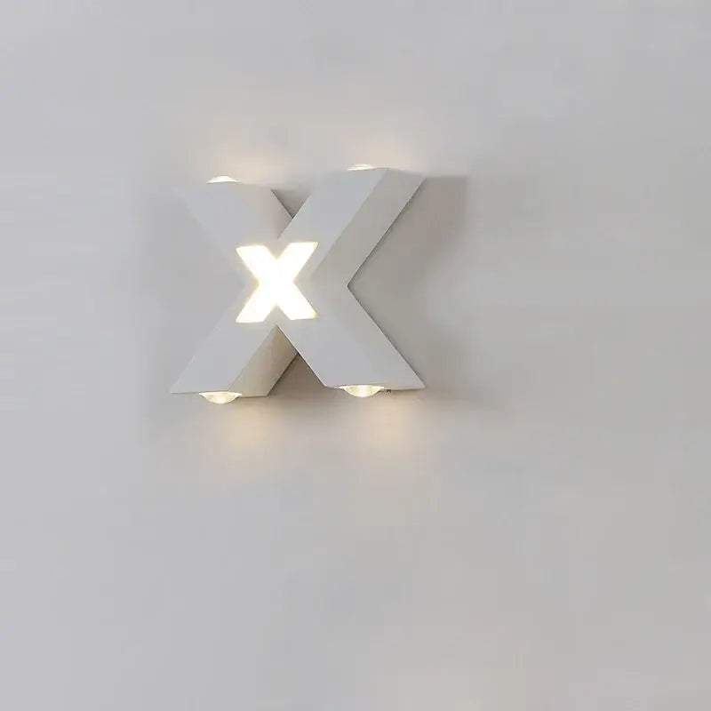 White aluminum X-shaped LED wall light emits soft, even glow from center and edges.