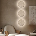 Three ORLUNE HOME Artistic LED Wall Lights glow vertically, adding vibrant illumination to walls.